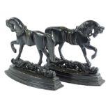 A pair of cast iron fire ornaments each modelled in the form of a horses.Provenance: The property of