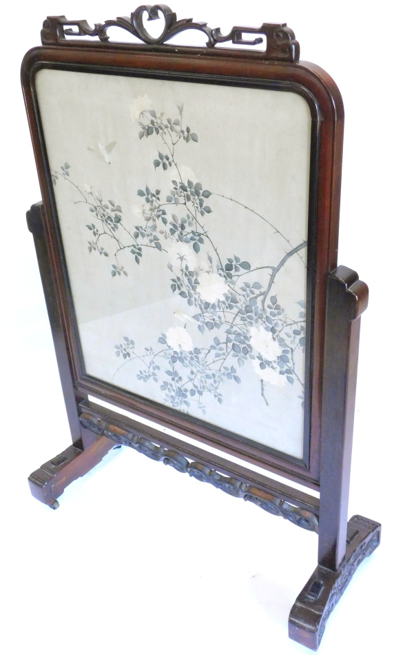 A late 19th/early 20thC Chinese hardwood screen, the frame carved with scrolls and with a pierced