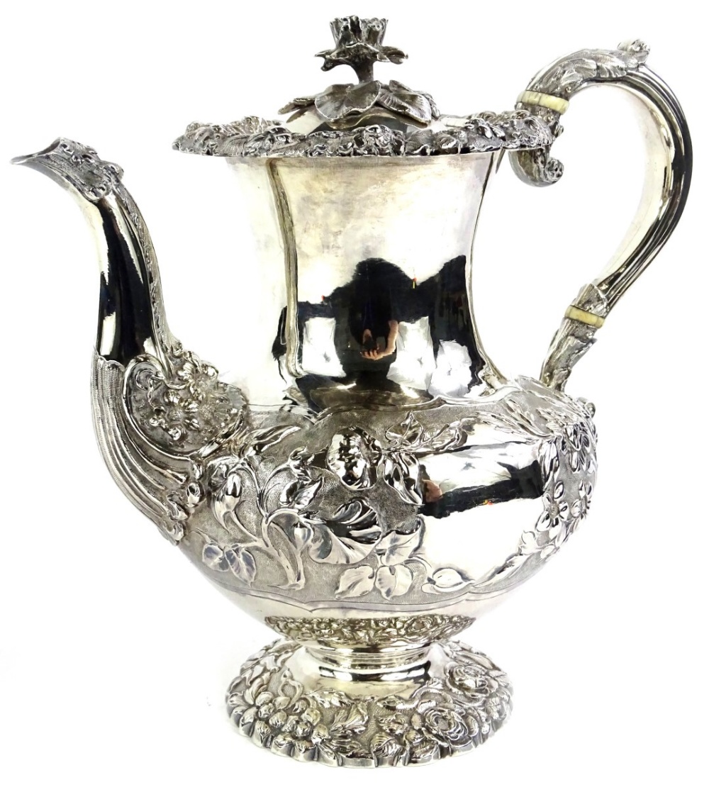 An early Victorian silver coffee pot, with embossed and repousse decoration of roses, other flowers,