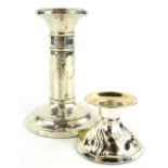 Two loaded silver candlesticks, to include an example decorated with Adam style swags, bows etc.,