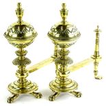 A pair of late 19thC aesthetic style fire dogs, each with a bulbous turned and engraved finial,