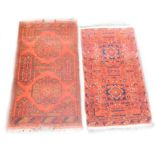 Two Turkish design small rugs, each with a design of medallions on a red ground, 94cm x 54cm and