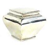 A silver sugar box or tea caddy, of square tapering form with gadrooned bands and a hinged lid,