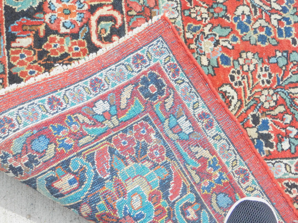 A Persian Meshed type carpet, with a design of flowers on a red ground with multiple borders, - Image 3 of 3