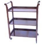 A mahogany three tier trolley, with turned handles and metal castors, 76cm W.Provenance: The