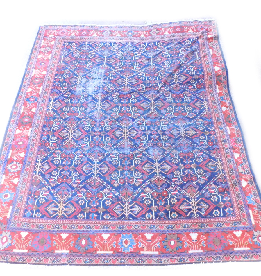 A Persian carpet, with an all over multi coloured design on a navy