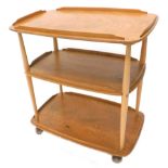 An Ercol elm three tier trolley, with a raised gallery on turned supports, on castors, 70cm W.