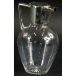 An Edwardian silver and glass claret jug, with angular handle in the manner of Christopher