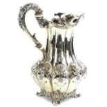 A late William IV silver hot water jug, with shaped sides, engraved with flowers etc., the scrolling