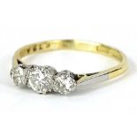 A three stone diamond ring, set with three round brilliant cut diamonds, in claw setting, with