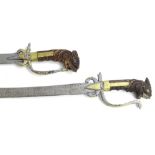 Two similar late 18th/early 19thC Ceylonese Kasane swords, each with a wooden handle carved in the