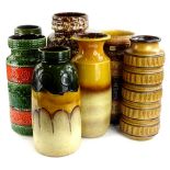 A collection of seven German fat lava type vases, decorated in various shades of green, brown, red