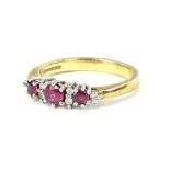 A 9ct gold dress ring, set with three garnets and tiny white stones, each in claw setting, ring size