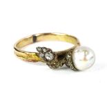 A cultured pearl and diamond acorn ring, with acorn design of single cultured pearl and the leaves