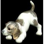 A Lladro porcelain model of a crouching puppy, 14cm L.