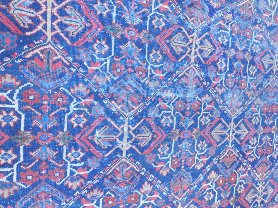 A Persian carpet, with an all over multi coloured design on a navy - Image 3 of 4