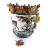 A 19thC Minton type Majolica jardiniere, decorated in relief with deer, flowers, leaves etc., (