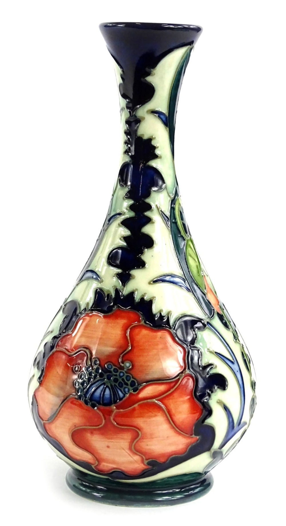 A Moorcroft pottery bottle shaped vase, decorated with a design of poppies, various impressed