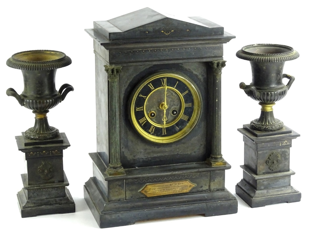 A late 19thC French black slate and metal marble clock, the clock itself modelled in the form of a