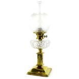 A Victorian brass oil lamp, with a part frosted shade, cut glass reservoir, the base decorated