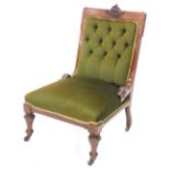 A Victorian walnut nursing chair, with a green buttoned padded back, padded seat on turned legs with