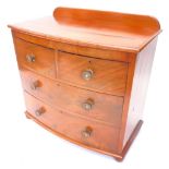 A Victorian mahogany bow fronted chest, the top with a raised back and a moulded edge above two