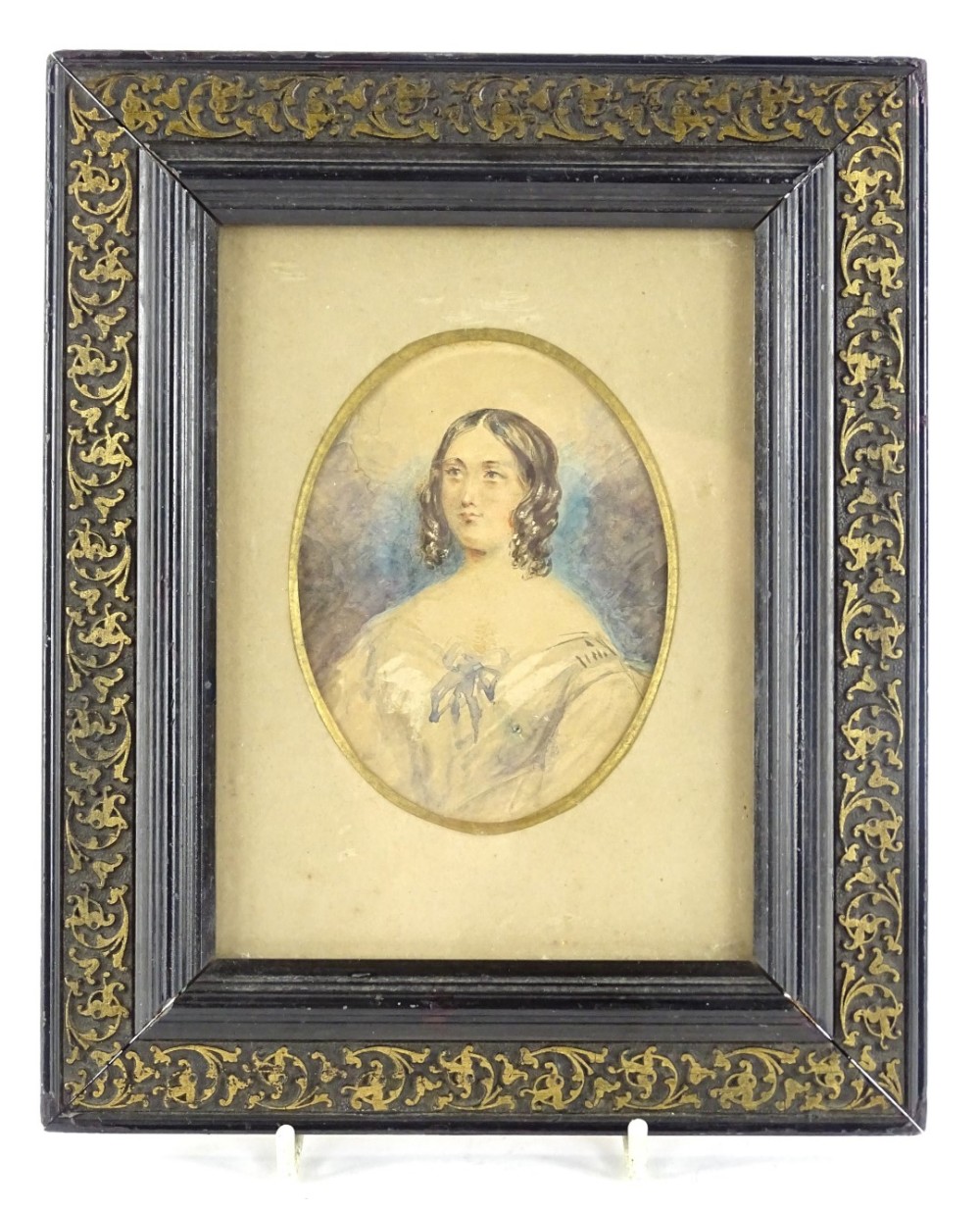 C.E.W (19thC), Portrait miniature of a lady wearing an ivory coloured dress with blue bow,