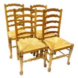 A set of four Lancashire type ladder backside chairs, each with a rush seat, turned tapering legs