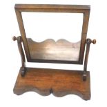 A Victorian mahogany dressing table mirror, the rectangular mirror plate on shaped supports with