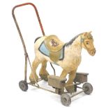 A Tri-ang composition push-a-long grey horse, with metal framework and plastic wheels, stamped to