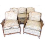 An early to mid 20thC mahogany bergere three piece suite, comprising three seater sofa with cane