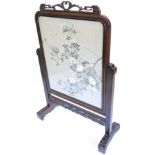 A late 19th/early 20thC Chinese hardwood screen, the frame carved with scrolls and with a pierced