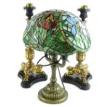 A modern Tiffany style desk lamp, the stained glass shade decorated with flowers etc., on a