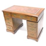 An early 20thC oak pedestal desk, the rectangular top with a later leatherette inset above an