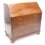 A George III mahogany bureau, the fall enclosing a fitted interior with later fret work panels,