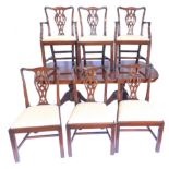 A mahogany extending dining table in Regency style, the rectangular top with cross banded border and