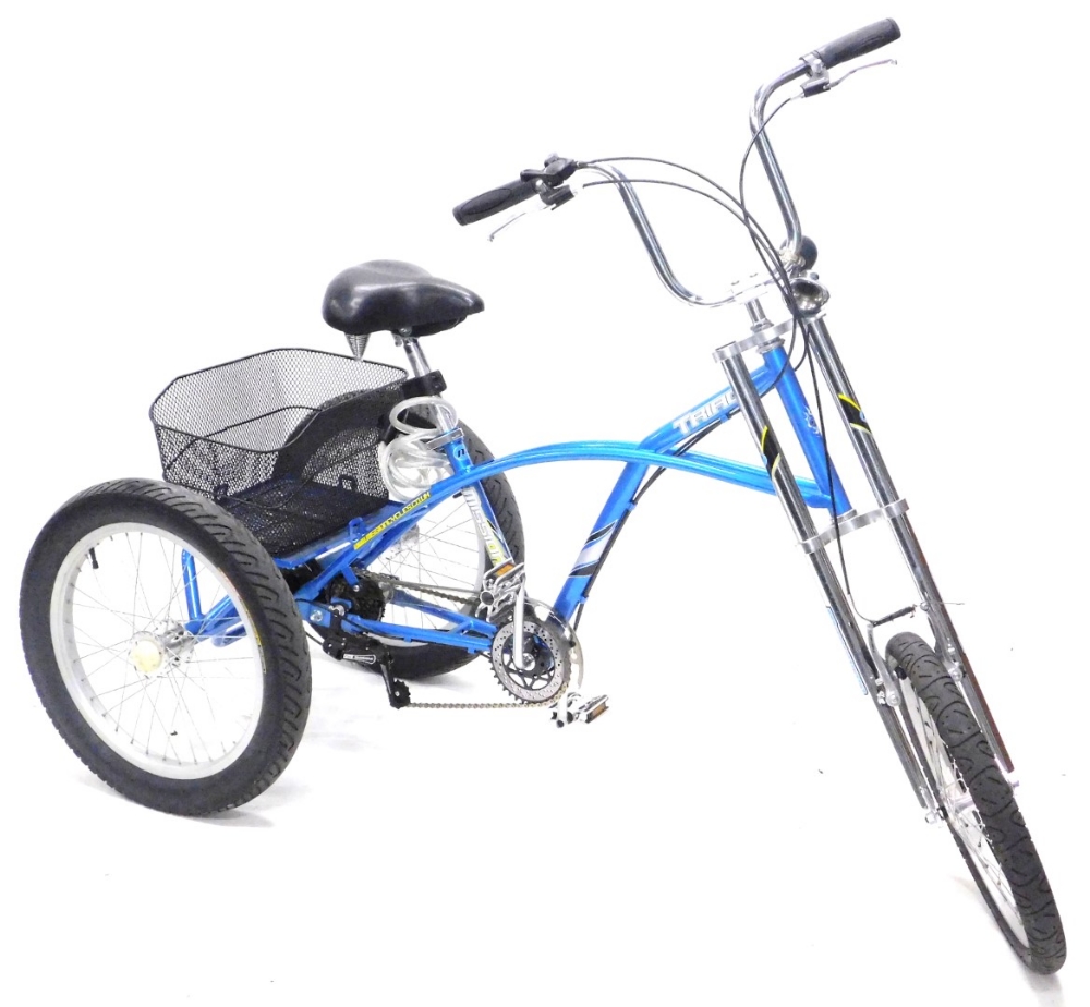 A Mission Triad chopper style tricycle, in blue with shopping basket to the rear.