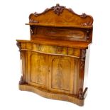 A Victorian mahogany chiffonier, the raised back carved with scrolls and with a shaped shelf, the