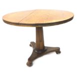 A Victorian pine breakfast table, with a circular top on octagonal column and triform base with