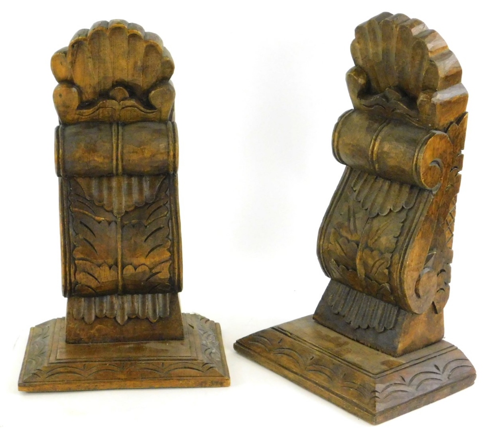 A pair of carved oak wall brackets, each decorated with leaves, shells etc., 43cm H.