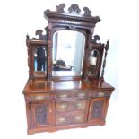 A late Victorian walnut and figured walnut sideboard, the raised back with a shaped crest above