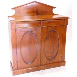 A Victorian mahogany and satin birch side cabinet, with a raised back above a moulded top and two