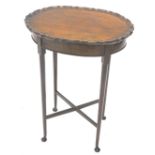 A mahogany occasional table, the oval top with a pie crust border on turned legs with pad feet, 50cm