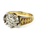 A 9ct gold dress ring, with central floral cluster set with white stones, and etched design