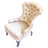 A Victorian ebonised nursing chair, with a buttoned back and padded seat, upholstered in gold damask