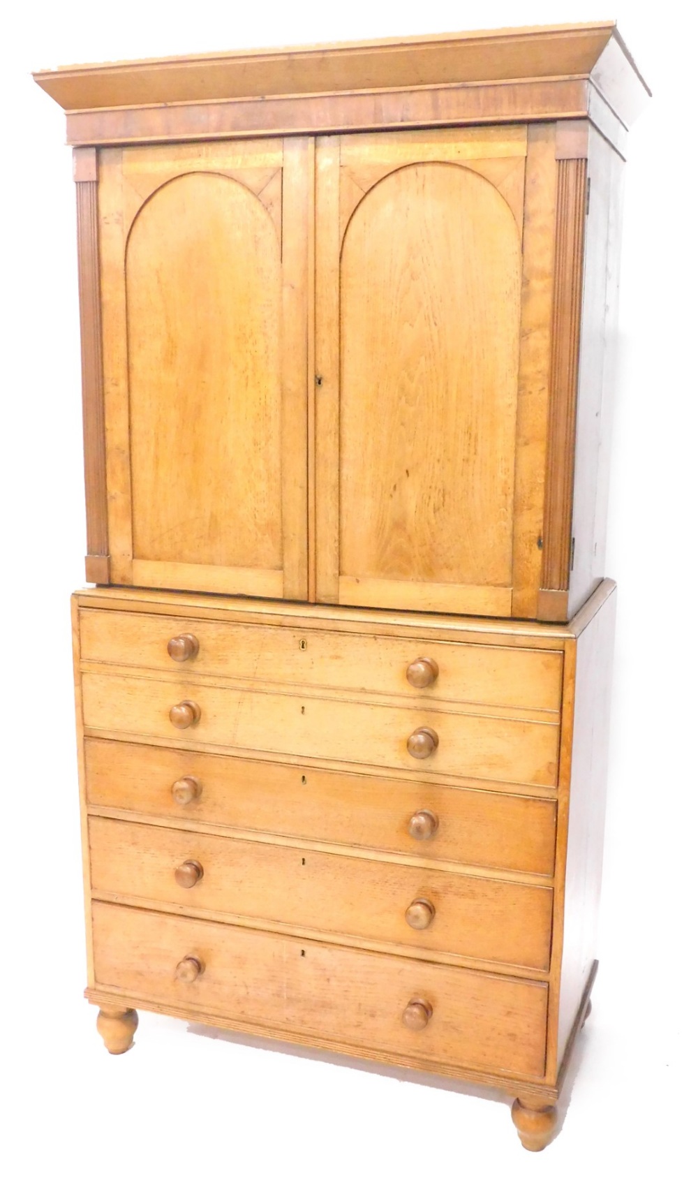 A Victorian oak secretaire cabinet, the top with a moulded cornice above two arched panel doors,