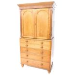 A Victorian oak secretaire cabinet, the top with a moulded cornice above two arched panel doors,