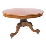 A mahogany coffee table, the circular top with a moulded edge on a short leaf carved column and