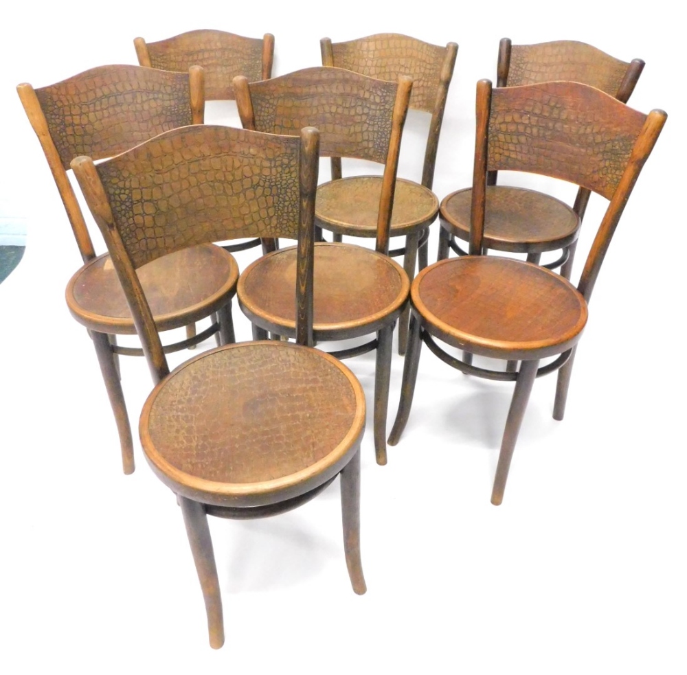 A set of seven Thonet beech bentwood chairs, each with a pressed simulated scale back and circular