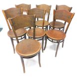 A set of seven Thonet beech bentwood chairs, each with a pressed simulated scale back and circular